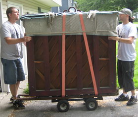 Two Leicester movers moving a Piano