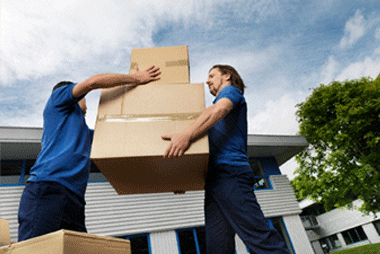 Two men moving boxes